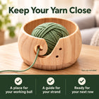 Wooden yarn bowl holding sage yarn